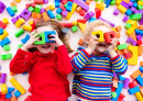 Happy Kids Playing with Toy Blocks